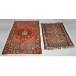 A Hamadan rug with central ivory medallion in a red field, measuring 196cm long, 138cm wide,