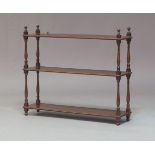 A Victorian mahogany three-tier wall shelf, each tier raised on slender baluster and ring turned