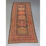 A Caucasian runner rug, with six medallions in charcoal field, multiple borders, early 20th Century,