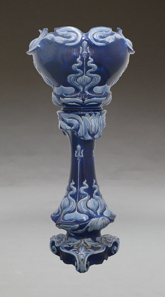 A Victorian jardinière and stand, in blue colour way with an internal pink glaze, 115cm high;