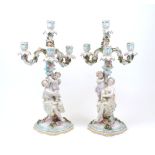 A pair of Sitzendorf three branch figural candelabras, 19th Century, of cream ground and turquoise