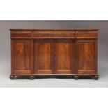 An early Victorian mahogany inverted breakfront sideboard, circa 1840, fitted with three frieze