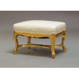 A 20th Century gilt painted rectangular stool, upholstered in cream cloth upholstery, raised on