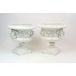 A pair of Continental white glazed pottery twin handled campana urns, 20th Century, the bodies