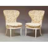 A pair of 19th Century white painted upholstered wing back chairs, upholstered throughout in a later