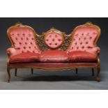A Victorian style walnut framed button upholstered three-seater settee, 20th Century, the frame with