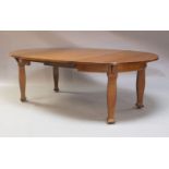 An Edwardian mahogany wind-out extending dining table, circa 1905, fitted with four removable