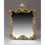 A 19th Century Rococo Revival gilt framed wall mirror, the top with a downward facing carved leaf,
