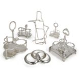A silver plated wine bottle coaster, together with a collection of silver plated cruet stands,