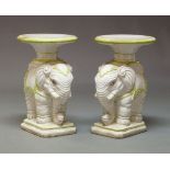 A pair of Italian figural elephant jardiniere stands, each with an oval top raised on an elephant