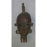 A Senufo bronze mask, Mali, second half 20th Century, the oval face with stylised features and