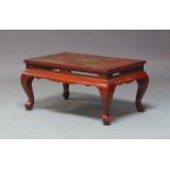 A Chinese red lacquered low table, mid 20th Century, the rectangular top decorated with gilt