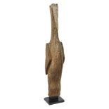 A Madagascan funerary post finial, carved as a tall stylised bird, on modern stand, 73cm high