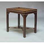 An early 20th Century Chippendale style mahogany occasional table, the top with a fretwork gallery