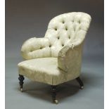 A Victorian deep button backed upholstered nursing chair, circa 1880, in a cream floral patterned