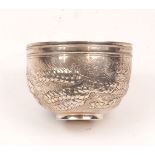 A white metal bowl repousse decorated with sheaves of wheat, unmarked, together with a white metal