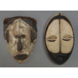 An Igbo mask, Nigeria, second half 20th Century, with applied white pigment and carved stylised