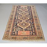 A Caucasian long rug, with four conjoined octagons in a deep blue field, with main border with