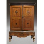 A German mahogany and ebonised kitchen cupboard, late 19th Century, the moulded cornice above two