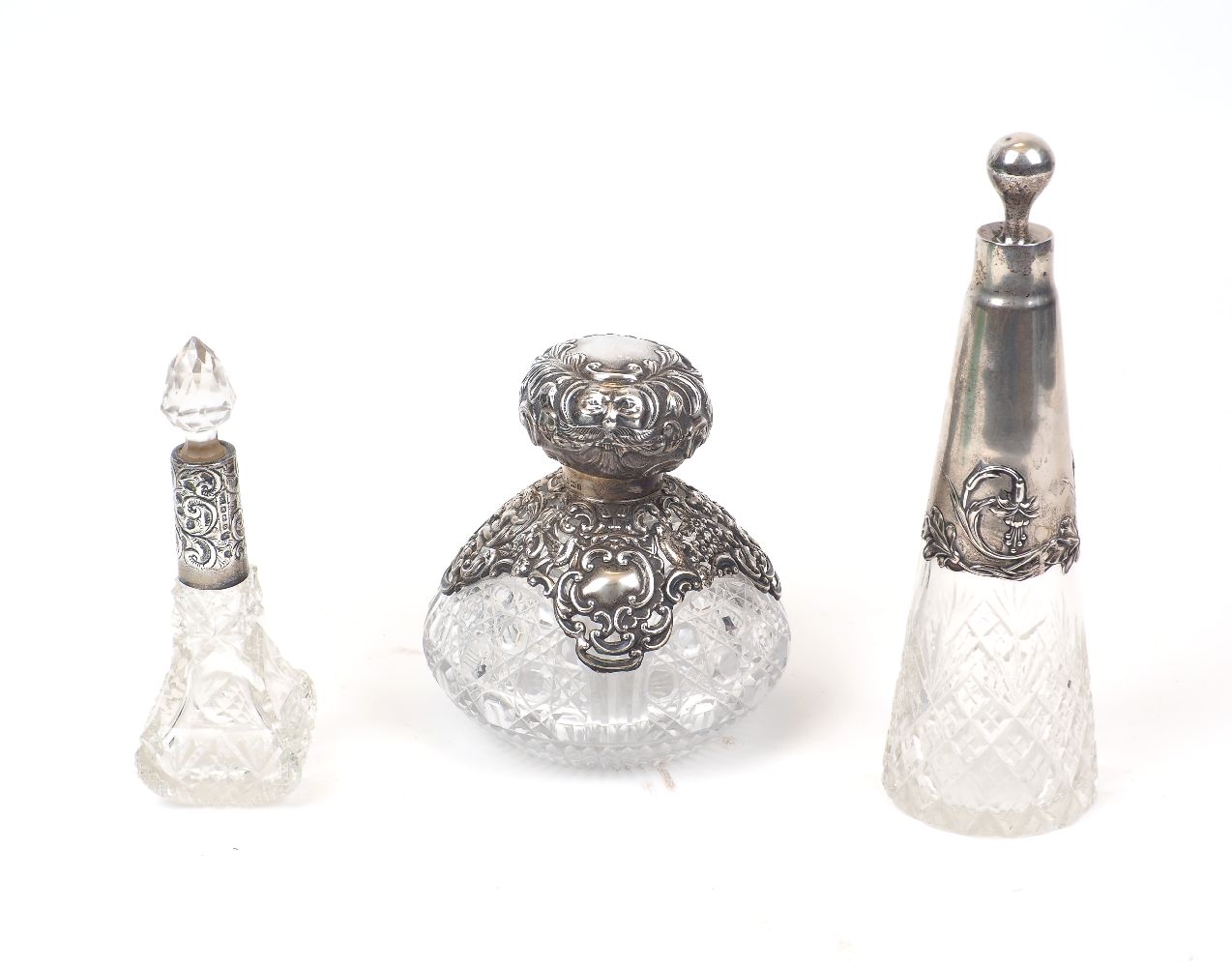 A German Art-Nouveau style silver mounted glass vanity bottle, of conical form with spherical silver