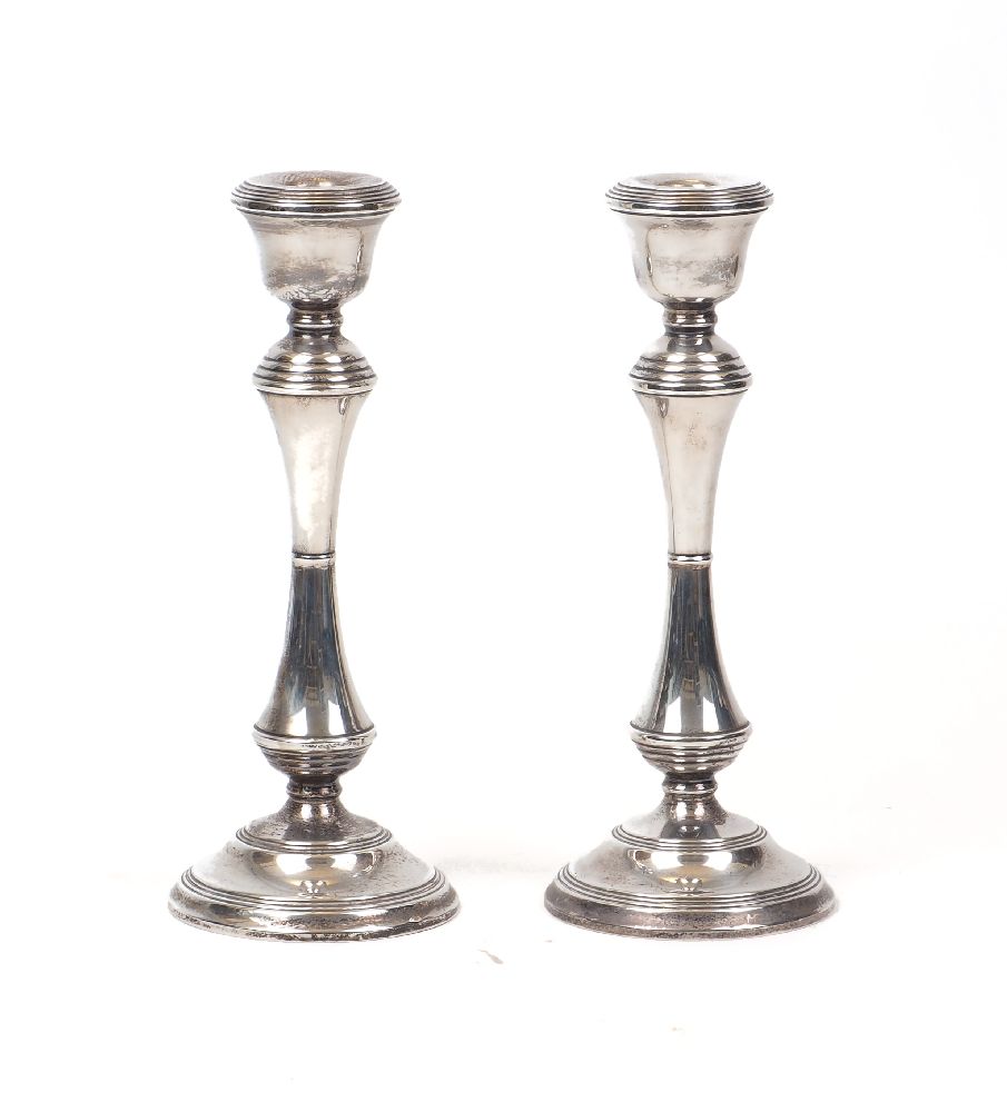 A pair of silver candlesticks, Birmingham, c.1989, W I Broadway & Co., designed with waisted stems