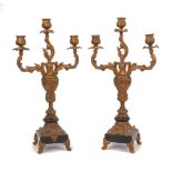 A pair of gilt spelter three light candelabra, 20th century, of Rococo style on black marble