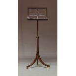 A Regency style mahogany adjustable music stand, 20th Century, having a slatted back support, raised