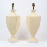 A pair of octagonal urn shaped table lamps, 20th Century, cream painted with white highlights and