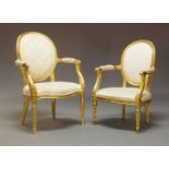 A French Louis XVI style giltwood open armchairs, the oval backs with padded upholstery, upholstered
