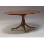 A Regency style mahogany pedestal dining table, of recent manufacture, the oval tilting top raised