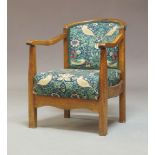 An Art Deco beech framed open armchair, c.1925, with William Morris style upholstered concave back
