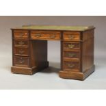A late Victorian mahogany twin pedestal writing desk, circa 1900, the top with a brass gallery