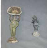 A lead birdbath, 20th Century, modelled as a winged putto with arms raised, 67cm high, together with