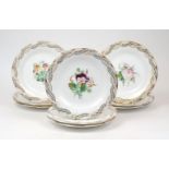 A group of nine Staffordshire plates, 19th Century, hand painted with floral sprays to the centre