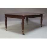 A Victorian mahogany extending dining table, fitted with three removable leaves, raised on turned