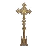 A large Continental Gothic Revival style brass altar cross, 19th Century, with embossed swag and