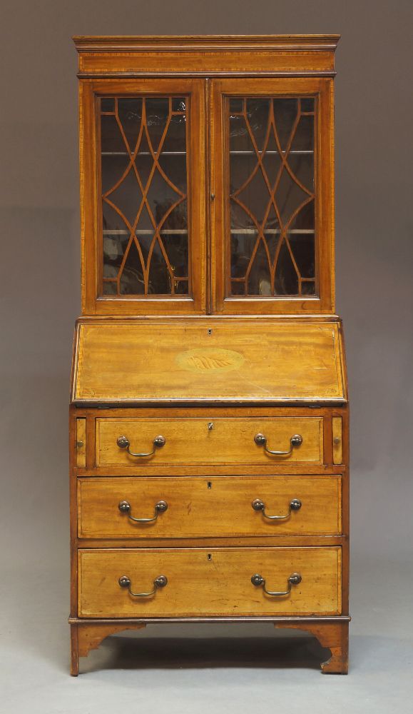 An Edwardian Sheraton Revival mahogany bureau bookcase, circa 1905, of diminutive proportions, the