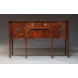 A George III style mahogany sideboard, 20th Century, with frieze drawer over deep drawer flanked