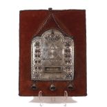 A gem-set Torah shield, the silver plated panel with three bells dependent designed with a Star of