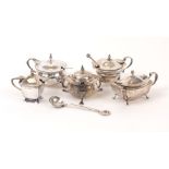 Five Edwardian and later silver mustards, and several condiment spoons, the mustards including one