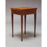 An Edwardian mahogany and line-inlaid games table, the folding top enclosing green baize lined