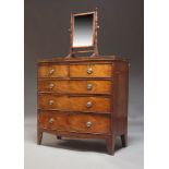 An early 19th Century mahogany bowfront chest, with two short over three long graduated drawers,