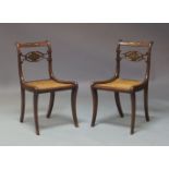 A pair of Regency mahogany and caned side chairs, the back rail and carved splat inset with brass