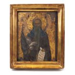 A Russian icon of a bearded saint, 19th Century, depicted holding a scroll and with oklad modelled