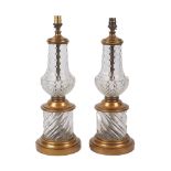 A pair of table lamps, 20th century, of baluster form, polished and press-moulded, gilt mounted,