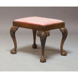 A George II style walnut stool, 19th Century, having a drop-in seat, raised on shell carved cabriole