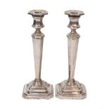 A pair of silver candlesticks, Sheffield, c. 1926 and 1928, James Dixon & Sons, the tapering,