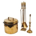 A collection of brassware comprising a brass coal bucket with lid and wrought iron swing carrying