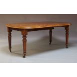 A late Victorian mahogany extending wind-out dining table and a set of four chairs, the table fitted