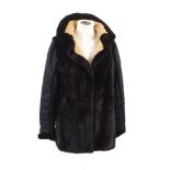 A reversible mink jacket, with black silk sleeves to one side, gold silk with two side pockets to